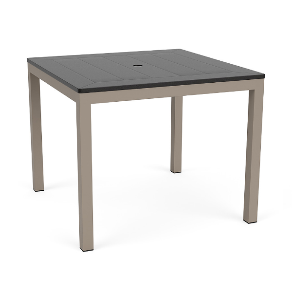 A 36-inch square commercial outdoor dining table featuring a dark slate grey panel-style Marine Grade Polymer (MGP) top with a center umbrella hole, mounted on a taupe powder-coated aluminum frame with four straight square legs and black glides.
