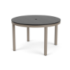 A 48-inch round commercial outdoor dining table featuring a mid-tone grey slatted Marine Grade Polymer (MGP) top with a center umbrella hole, supported by a warm taupe/grey powder-coated aluminum frame with four straight square legs.