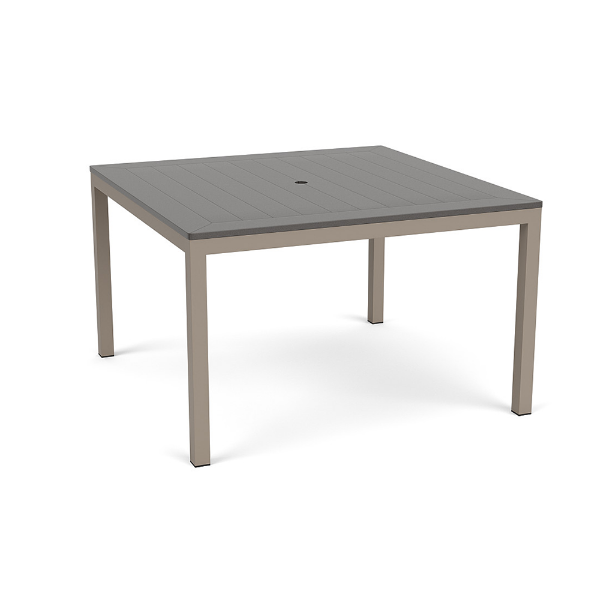 A 48-inch square commercial outdoor dining table featuring a mid-tone grey panel-style Marine Grade Polymer (MGP) top with a center umbrella hole, supported by a warm taupe/grey powder-coated aluminum frame with four straight square legs.