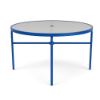 A 48-inch round commercial acrylic outdoor dining table featuring a vibrant blue powder-coated aluminum frame, straight legs with lower cross-bracing, a central umbrella hole, and a textured clear acrylic top.