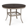 A round commercial patio dining table with a satin powder-coated aluminum base, crisscross stability bracing, an umbrella hole, and a dark Amber Grey MGP surface.