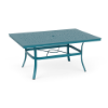 A 42x60-inch rectangular commercial outdoor dining table featuring a Metallica Lagoon blue-teal powder-coated aluminum frame, four curved legs, an umbrella support brace, and a perforated bubble pattern top with a central umbrella hole.