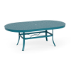 An oval 42x76-inch commercial outdoor dining table featuring a Metallica Lagoon blue-teal powder-coated aluminum frame, curved legs, an umbrella ring brace, and a perforated bubble pattern top with a central umbrella hole.