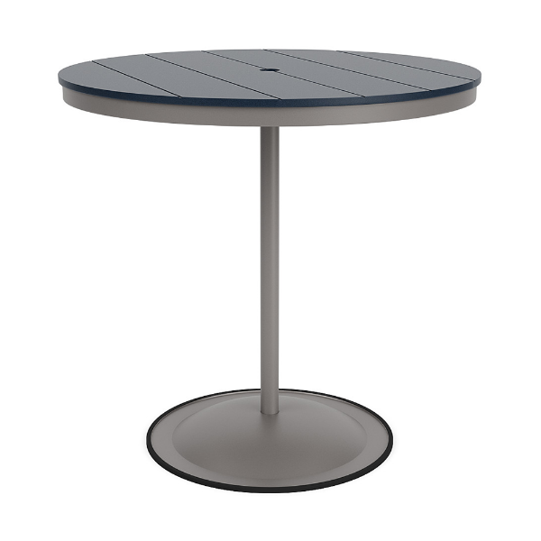 A 42-inch round commercial patio bar table built with a Platinum metallic powder-coated aluminum pedestal base and a circular weighted stand, featuring a navy blue Marine Grade Polymer (MGP) slatted surface with an umbrella hole.
