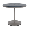 A 48-inch round commercial patio bar table built with a Platinum metallic powder-coated aluminum pedestal base and a circular weighted stand, featuring a navy blue Marine Grade Polymer (MGP) slatted surface with an umbrella hole.