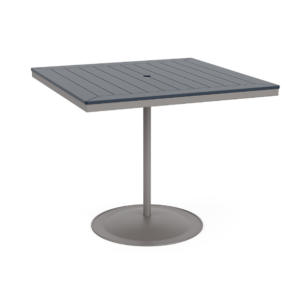 A 48-inch square commercial patio bar table built with a Platinum metallic powder-coated aluminum pedestal base and a circular weighted stand, featuring a navy blue Marine Grade Polymer (MGP) slatted surface with an umbrella hole.