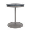 A 24-inch round commercial patio dining table built with a Platinum metallic powder-coated aluminum pedestal base and a circular weighted stand, featuring a navy blue Marine Grade Polymer (MGP) slatted surface with an umbrella hole.
