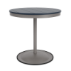 A 30-inch round commercial patio dining table built with a Platinum metallic powder-coated aluminum pedestal base and a circular weighted stand, featuring a navy blue Marine Grade Polymer (MGP) slatted surface.
