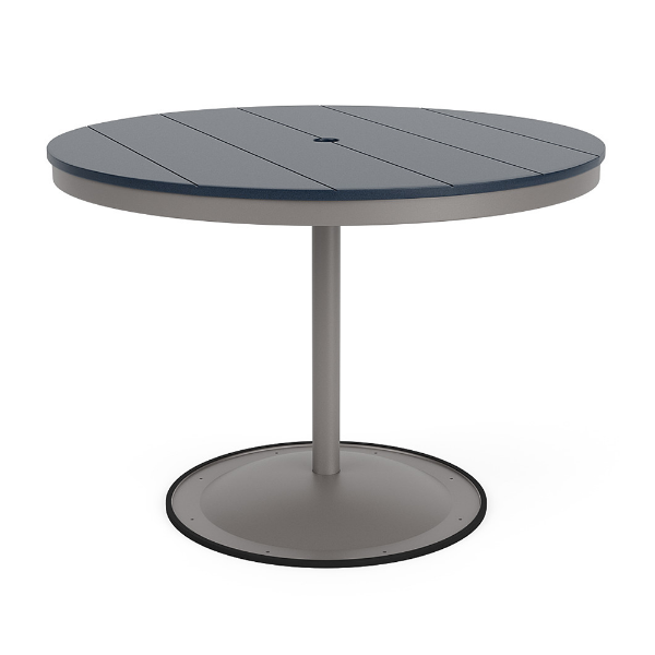 A 42-inch round commercial patio dining table built with a Platinum metallic powder-coated aluminum pedestal base and a circular weighted stand, featuring a navy blue Marine Grade Polymer (MGP) slatted surface with an umbrella hole.
