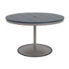 A 48-inch round commercial patio dining table built with a Platinum metallic powder-coated aluminum pedestal base and a circular weighted stand, featuring a navy blue Marine Grade Polymer (MGP) slatted surface with an umbrella hole.
