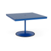 A 48-inch square commercial outdoor dining table featuring a Marina bright blue powder-coated aluminum pedestal post and round weighted footing, paired with a Royal Blue Marine Grade Polymer (MGP) slatted tabletop and a center umbrella opening.