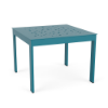 A square aluminum commercial outdoor side table in Lagoon blue featuring an asymmetrical bubble dot pattern cut out on the table top.