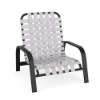 A commercial outdoor low-profile sand chair with a textured charcoal black aluminum frame and bright white vinyl straps woven in a cross-weave pattern across the seat and back.